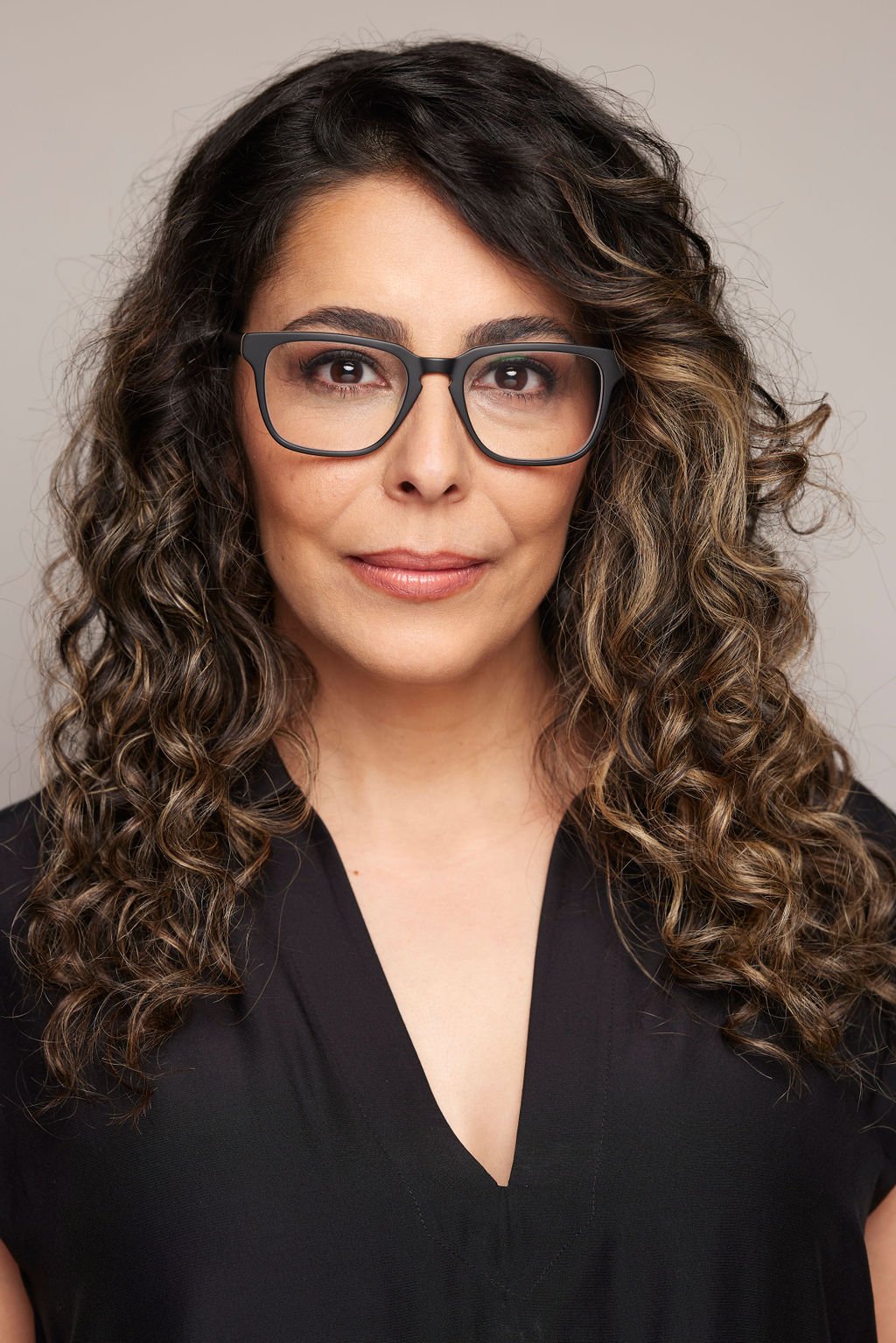 Azadeh Zanjani headshot wearing glasses